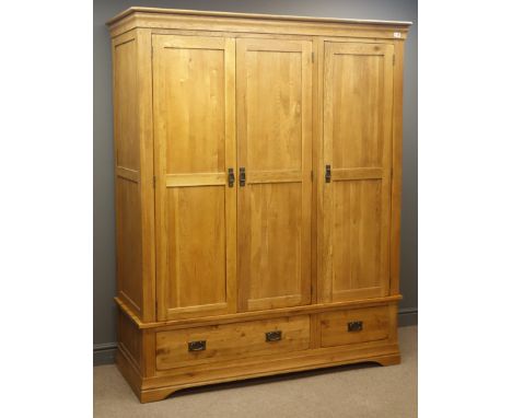 Light oak triple wardrobe, projecting cornice, three panelled doors enclosing fitted interior above one long and one short dr