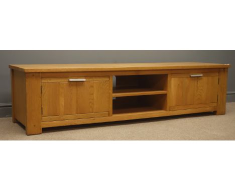 Light oak television stand, centre shelves flanked by two cupboards, stile end supports, W180cm, H46cm, D51cm Condition Repor