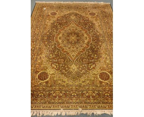 Persian Kashan design carpet, olive green ground, interlaced field with shaped medallion decorated with flowers and foliage, 