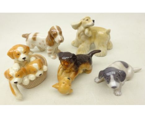 Four Royal Copenhagen dogs; Cocker Spaniel 040, Pointer Puppy 1311, Puppies Playing 746 and Puppy Collection 745 and a Bing &