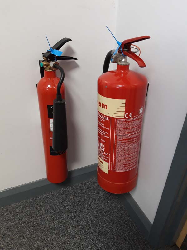 Approx 12 assorted fire extinguishers with assorted first aid kits and