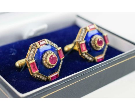 A PAIR OF RUBY AND DIAMOND CUFFLINKS, silver-gilt, each of octagonal form, set with rubies and diamonds, blue enamelled bands