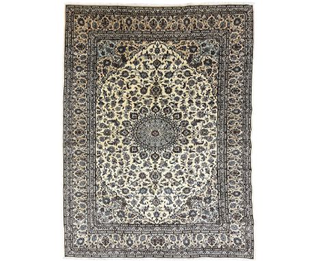 Persian Kashan indigo ground carpet, the field decorated with a central floral medallion surrounded by interconnecting palmet