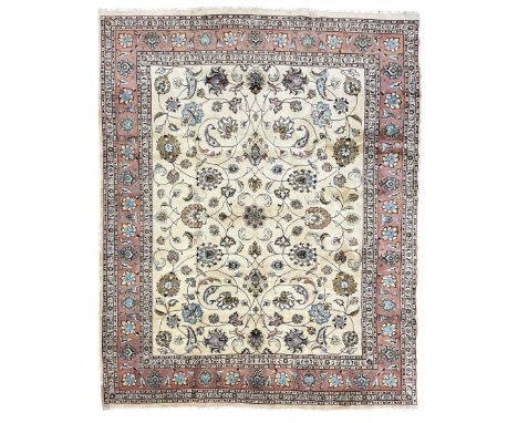 Persian Meshed ivory ground carpet, the field decorated with interlaced branches and stylised plant motifs with birds, peach 