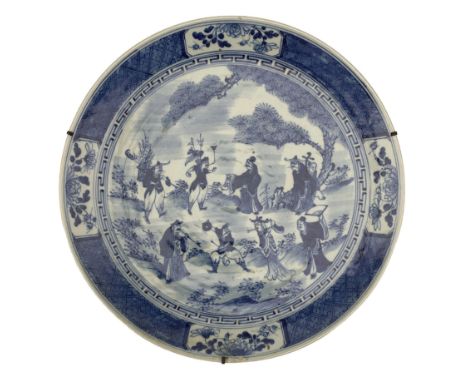 Chinese Qing Dynasty 'Eight Immortals' blue and white charger, centrally painted with a scene of the eight immortals in a gar