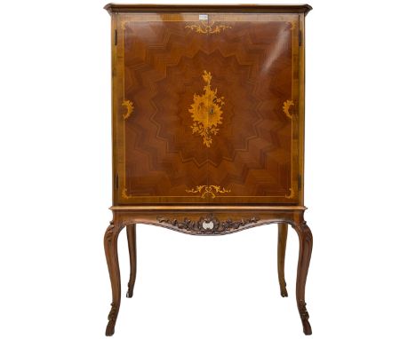 Italian marquetry inlaid walnut drinks cabinet, the doors with central satinwood floral cartouche inlay and extending star pa