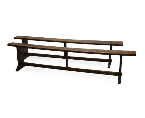A Pair of Primitive Joined Oak Long Benches, 19th century, the one-piece tops above standard end supports and sledge bases jo