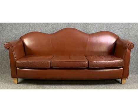 A serpentine back three seater sofa in tan leather upholstery raised on tapering block supports. H.88 W.190 D.75cm