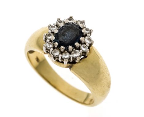 Saphir-Brillant-Ring GG/WG 750/000 mit einem oval fac. Saphir 6,4 x 5,0 mm Dunkelblau, opak und 12 Brillanten, zus. 0,20 ct g