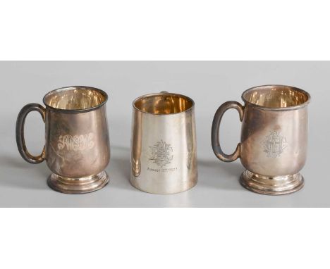 Three silver mugs, One London, 1926 and Two Birmingham, 1957 and 1958, each variously tapering cylindrical, engraved with dif