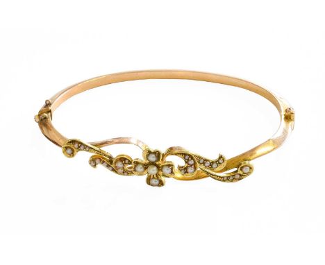 A Split Pearl Bangle, of floral and leaf design, stamped '15CT', inner measurements 6cm by 4.4cm (a.f.)Gross weight 9.7 grams