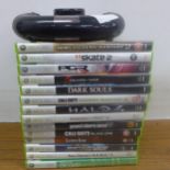 An XBox 360 wireless Speed Wheel controller and a quantity of XBox 360 games including Skate 2,