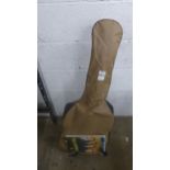 A Hokada 3342 acoustic guitar with stand, sheet music and case