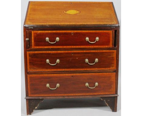 An Edwardian mahogany bureau, the top with a wide crossbanding above a shell inlaid fall front hinging to reveal a part fitte