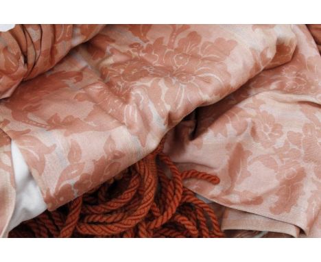 A set of drape curtains, in peach and white floral material.