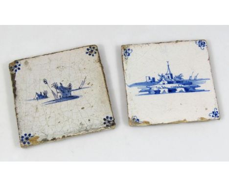 An early 18thC Dutch delft blue and white tile, naively decorated with floral spandrels, 14cm x 13cm, and another of a church