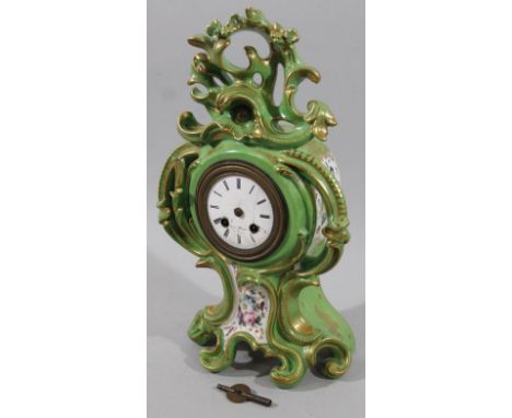 A 19thC French Marc porcelain clock, the 7cm dia enamel dial revealing a key wind movement set with Roman numerals in a heavi