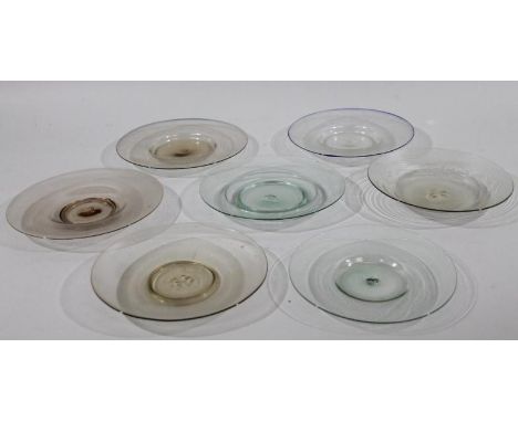 Seven various early 19thC glass saucers, each of dished outline with rough pontil marks, various shades, 17cm dia. (a quantit