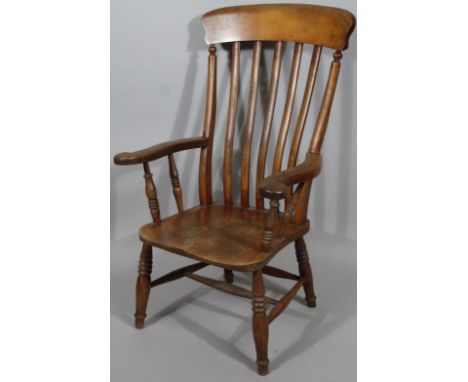 A 19thC ash and elm slat back grandfather chair, with stylized comb top, serpentine arms and triple ring turned supports join