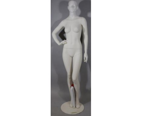 *A modern tailor's mannequin dummy, female, full profile on circular metal stand, painted cream, 180cm high. 