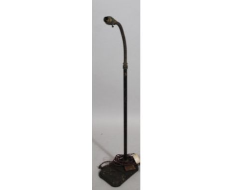 A mid 20thC physician's lamp, with articulated metal top, fixed stem and shaped base with electrical fitting, 97cm high. 