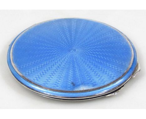 A George VI silver part enamel and mirrored powder compact, the shaped circular body part engine turned in blue with thumb op