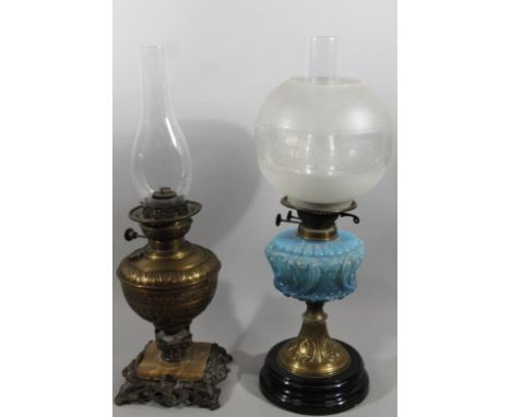 An early 20thC brass oil lamp, with frosted and clear glass shade, clear glass reservoir, moulded blue glass centre and brass