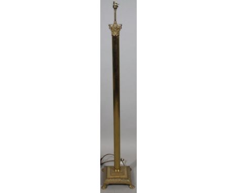 A 20thC brass Corinthian column lamp, standing on a square base terminating in quadruple hairy paw feet with electrical fitti