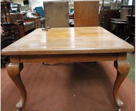 *A late 19thC light oak wind out dining room table, the rounded top raised on heavy cabriole supports terminating in club fee