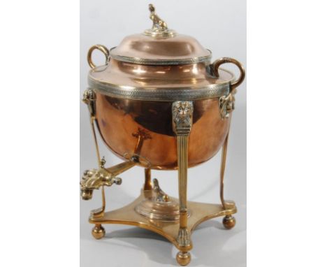 A mid 19thC copper and brass samovar, the compressed oval body surmounted by a domed lid with sphinx and part pierced knop fl