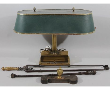 A mid 20thC brass desk lamp, with overhanging canopy hood, surmounted by acorn finials on a turned fluted column on heavy ste