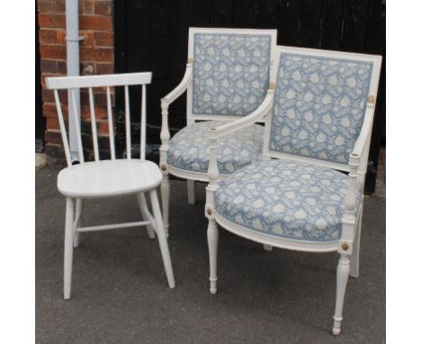 Two Regency style painted wooden chairs, with floral upholstery to the back and overstuffed shaped seats, on turned baluster 