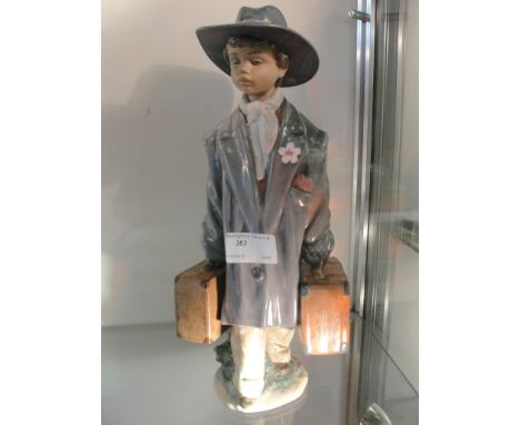 A Lladro Le Gres boy dressed as a man
