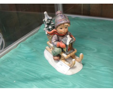 A large Hummel figure of a boy on sledge