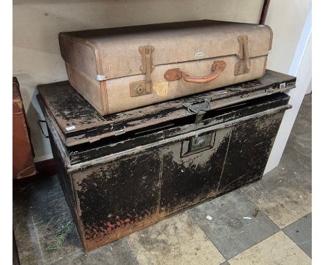 A black metal trunk and a suitcase 