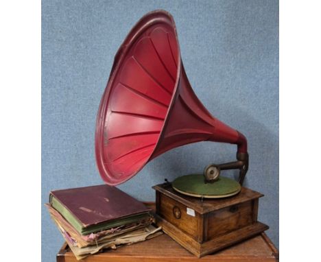 A Beltons wind-up table top gramophone with large red metal speaker horn, with records, handle and needles 