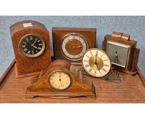 Four assorted early 20th Century clocks and an aneroid barometer 
