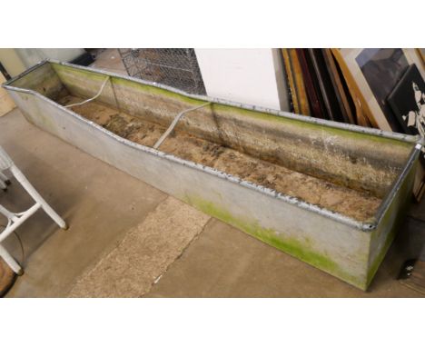 A large galvanised feeding trough 