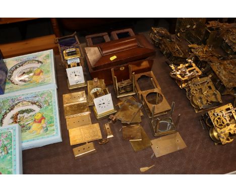 A brass cased carriage time piece with outer traveling case and a quantity of various carriage clock parts, a mahogany tea ca
