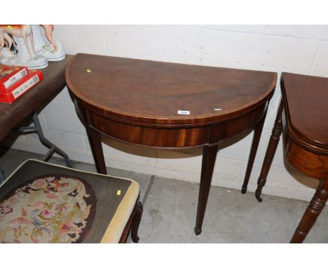 A 19th Century mahogany and cross banded demi-lune shaped fold over card table 