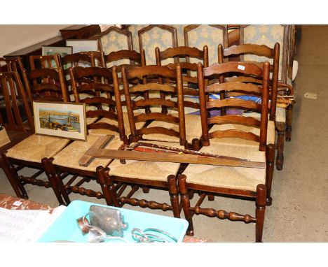 A set of eight oak ladder back dining chairs with rush seats