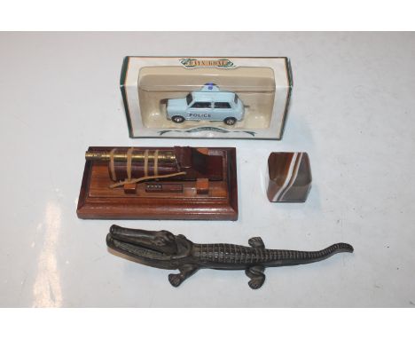 A Days Gone By boxed die-cast model; an Austin 7 mini from South Wales Police; a brass model of a cannon; a nutcracker in the