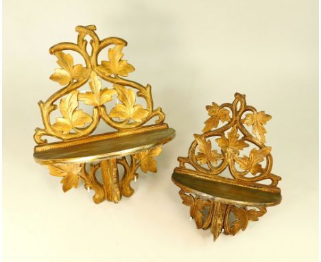 FOLDING SHELF BRACKETS. Two carved gilt wood, folding wall shelf brackets. Largest, height 32cm.