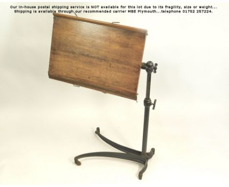 READING STAND.A Victorian Patent cast iron & oak reading stand/table, the oak top with twin-hinged rests. The cast iron frame