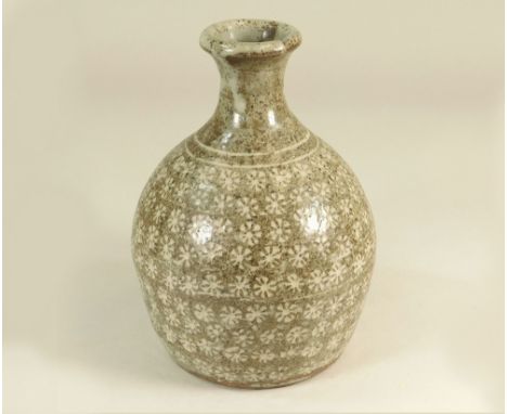 TREVOR CORSER. A bottle vase decorated with bands of stylised flower heads. Height 17cm. Personal &amp; Leach Pottery marks.