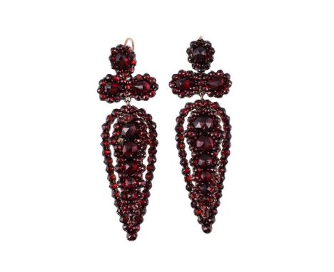 
	
		A PAIR OF LATE 19TH CENTURY BOHEMIAN GARNET EARRINGS 
		The articulated trefoil pediments above pear shaped drop panels 