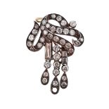 A SCROLLING DIAMOND SET BROOCH