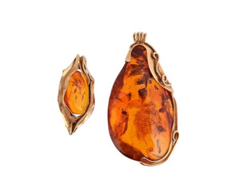 
	
		J.B S&#216;RENSEN, A CLARIFIED AMBER PENDANT AND BROOCH 
		The oval shaped polished amber pendant with insect inclusions