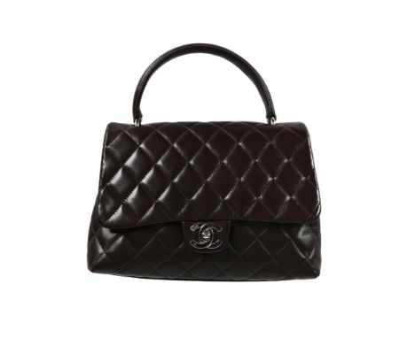 
	
		CHANEL, A CHOCOLATE QUILTED LAMBSKIN HANDBAG 
		With top loop handle, white metal hardware, the quilted flap opening to 