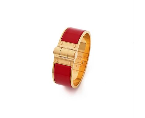 
	
		HERM&#200;S, &#39;CHARNIERE&#39;, A RED AND GILT HINGED BANGLE  
		The gilt bangle with a red enamelled insert, push but